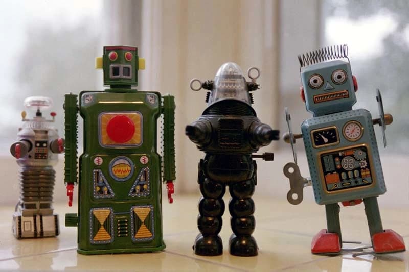 An army of small toy robots representing AI at scale